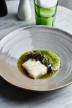 Appetizing fine dining plated main course dish of halibut filet