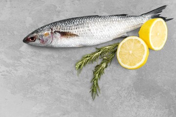 Fresh tasty fish for cooking dish on table with lemon