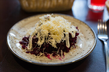 dish of beets, cheese, mayonnaise on a plate in restaurant