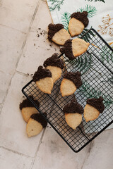 Acorn-shaped shortbread cookies with chocolate icing and sprinkles. Autumn themed baking. Homemade...