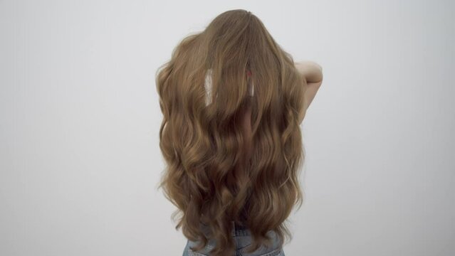 Gorgeous falling hair in slow motion. Rear view.