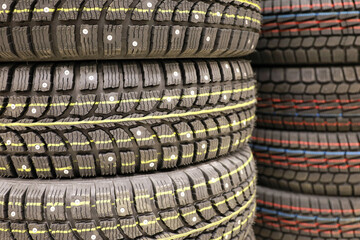 Studded tires of car wheels in a store. Rubber for the winter season