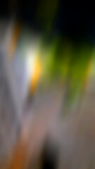 Abstract blurred background with a predominance of gray, there is also a little green and orange.