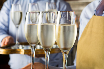 glasses of champagne served by waiter