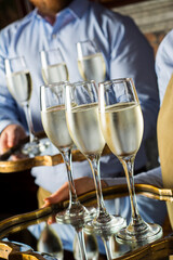 glasses of champagne served by waiter