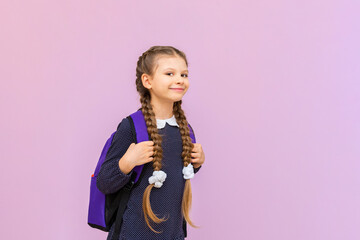 Children's primary education, a little girl in a school uniform with glasses and pigtails.
