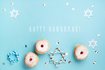 Jewish holiday Hanukkah concept - Hanukkah sweet doughnuts sufganiyot with powdered sugar and fruit...