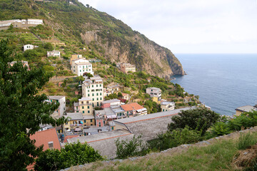 View of the colorful houses along the coastline of Cinque Terre area in Riomaggiore, Italy