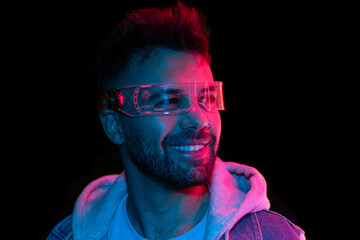 Caucasican man in futurisct glasses, watching 360 degree video with virtual reality headset isolated on black background