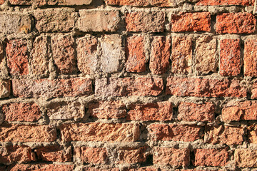 Old brick wall background, brick wall texture, structure. old broken brick, cement joints, close-up. Construction, repair. Concept of devastation, decline.