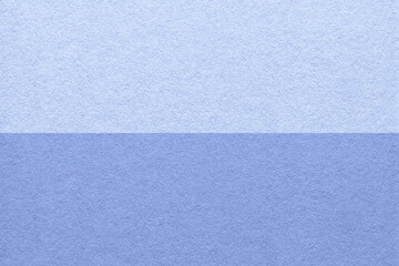 Texture of craft light blue and very peri paper background, half two colors, macro. Vintage denim cardboard