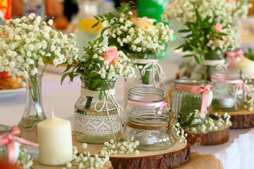 Beautiful floral arrangements, bouquets of flowers in vases and vintage jars