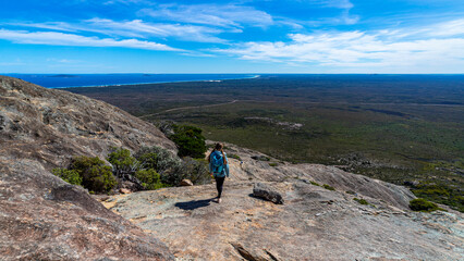 brave backpacker girl descends from frenchman peak in cape le grand national park in western...