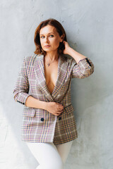 attractive and sexy brunette woman in a plaid jacket on a naked body. 
