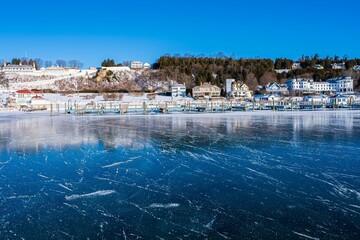 Beautiful view of a frozen lake and buildings in the background.