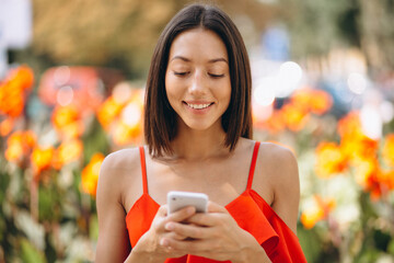 Portrait of beautiful woman smiling and using phone