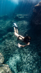 Naklejka na ściany i meble girl diving in mediterranean sea 