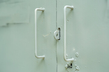 Hand-welded metal handles to steel gates.