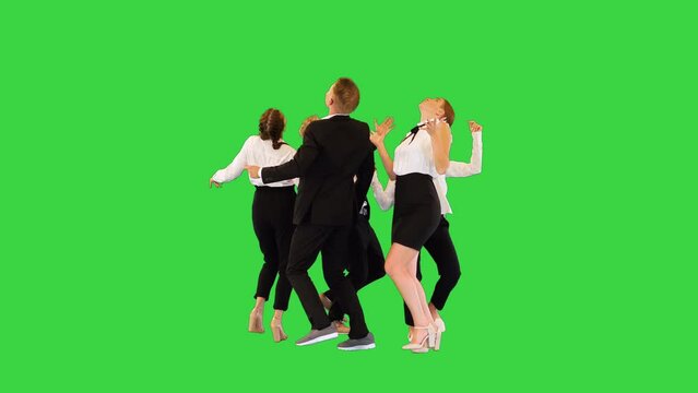 Carefree office workers perform weird round dance, looking up on a Green Screen, Chroma Key.