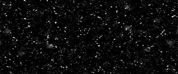 Falling snow isolated on black background. Falling snow at night. Bokeh lights on black background, flying snowflakes in the air. Winter weather. Overlay texture.