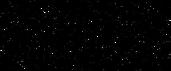 Falling snow isolated on black background. Falling snow at night. Bokeh lights on black background, flying snowflakes in the air. Winter weather. Overlay texture.