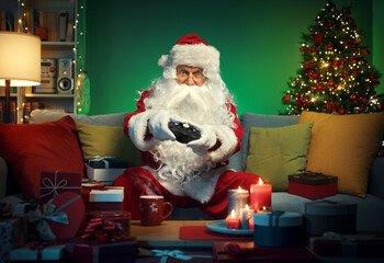 Happy Santa Claus playing video games at home © StockPhotoPro