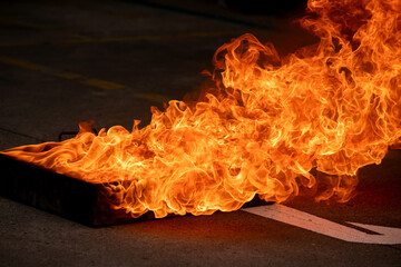 Close up of fire burning flame on the oil tray. Event of fire fighting and fire drill training.