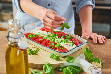 Unrecognizable woman preparing Caprese
