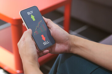 businessman buy and sell the assets stock trading online on phone. Investment concept and business...