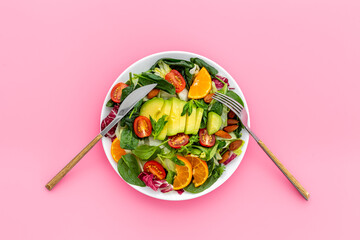 Healthy vegetarian bowl of green salad with avocado and tomatoes