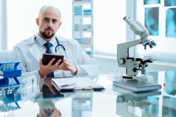 Naklejka na ściany i meble scientist using a digital tablet in a medical lab.