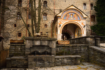 Entrance gate to Rila Monastery the largest and most famous Eastern Orthodox monastery in Bulgaria, photographed under overcast weather.