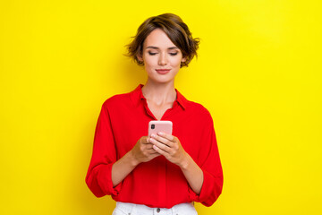 Photo of nice positive cute lovely girl with bob hairdo dressed red shirt chatting video call webcam isolated on yellow color background