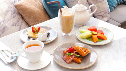 Sweet delicious breakfast with pancake, waffles, coffee and fruits