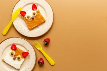 Fox faces sandwiches for funny kids breakfast. Sandwich made from peanut butter and strawberries