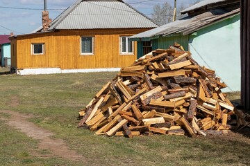 Pile of chopped pine wood in the yard on the grass