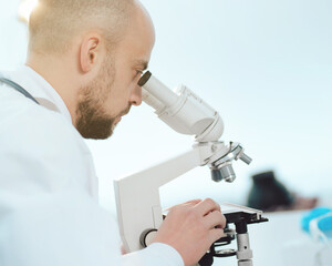 scientist using a microscope in the lab. side view.