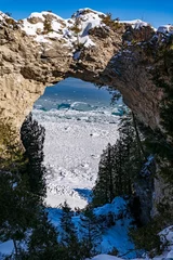 Tuinposter Tropisch strand Beautiful shot of a rocky arch in Mackinac island during winter