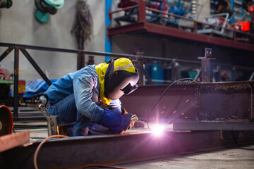 Welding male worker metal steel is part of beam structure