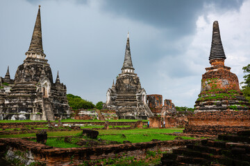 Fototapeta premium Ayutthaya, Thailand - October 5, 2022: Group touring pagoda Wat Phra Sri Sanphet Temple in the precinct of Ayutthaya, Historical Park, a UNESCO World Is one popular tourist destination