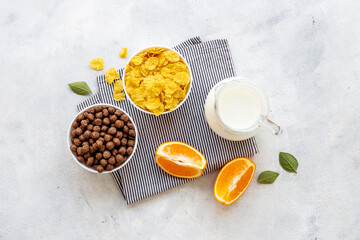 Healthy corn flakes with fruits for breakfast, top view