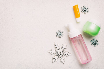 Makeup products and Christmas decorations on color background. Top view New year Beauty concept with copy space