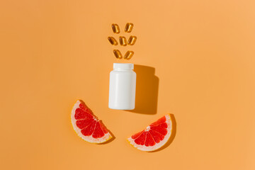 White vitamin bottle with citrus fruits and pills top view, bio supplement, vitamin C - obrazy, fototapety, plakaty