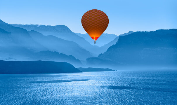 Blue mountain landscape with fog and pine forest at sunset - 
Hot air balloon fly over blue mountains and sea