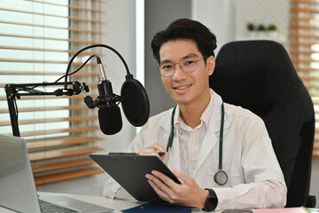 Health radio program or online podcast by an Asian male Doctor, social media and trends concept.