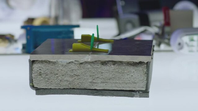 Different type of construction materials on testing table inside modern futuristic laboratory .  Construction experts doing experiment . Seismologist lab . Concept of quality checking or control
