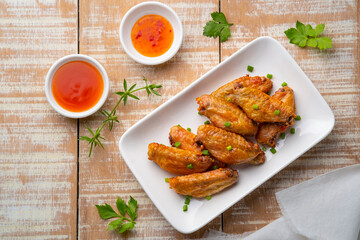 Air Fryer Chicken middle wing stick (wingette) with Fish Sauce on white plate.Top view