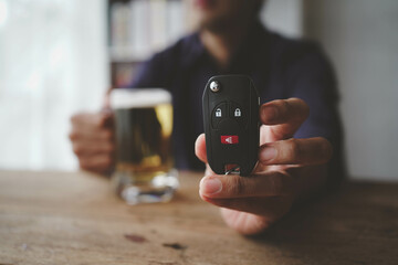 Two friends toasting with glasses of light beer on the wooden background. 