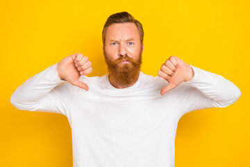 Photo of young unhappy funny guy red beard hair mustache angry depressed upset dislike thumbs down isolated on yellow color background