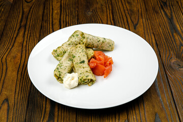 delicious pancakes with salted salmon on a plate.
